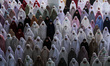 Indonesian Muslims are seen attending the Eid al-Adha prayer at the Islamic Center Mosque,...
