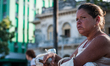 A woman takes a break in a park to smoke a cigar in Santa Clara, Cuba on April 5, 2014. 
