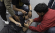 Protesters pour water in the faces of those injured by tear gas. The Police fired rubber b...
