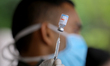 A Sri Lankan Army soldier attached to the medical unit loads a syringe with China's Sinoph...
