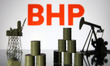 BHP logo and models of an oil rig, pump jack and oil barrels are pictured in this illustra...