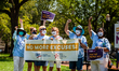 Members of the Arizona chapter of the League of Women Voters raise their fists during a vo...