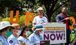 Members of the Arizona chapter of the League of Women Voters (LWV) display a banner while...