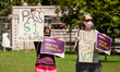 Protesters display signs calling for voting rights protections and an end to the filibuste...