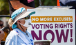 A member of the Arizona chapter of the League of Women Voters stands next to the podium du...