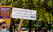 A protester holds a sign against gerrymandering during a voting rights rally at the White...