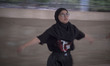 Khadijeh Taheri-22, an Afghan refugee kickboxer, warms-up herself as she takes part in an...