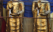 Two large statues of Lord Buddha rest along the roadside before being transported to a loc...