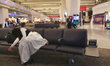 Muslim girl takes a nap at around 3AM while waiting for an early morning flight to Kabul f...