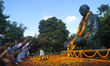 People pay floral tribute to the statue of Mahatma Gandhi at a public park on the occasion...