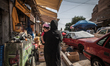 A woman with her child walks through the busy streets of Erbil / Summer 2013. 