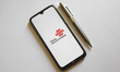 In this photo illustration a China Unicom logo is display on a smartphone screen and a pen...