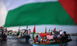 Palestinians riding boats hold Palestinian flags during a protest against the killing of 1...
