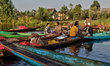 Merchants and shoppers at the floating vegetable market on Dal Lake in Srinagar, Kashmir,...
