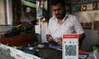 A QR code of Airtel Payment Bank is seen at a mobile repairing shop in Kolkata, India, Nov...