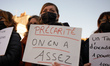 A woman holds a placard reading 'Precarity, we're fed up'. Educators on strike gathered in...