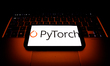 PyTorch logo displayed on a phone screen and a laptop keyboard are seen in this illustrati...
