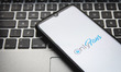 In this photo illustration an OnlyFans logo seen displayed on a smartphone screen with a c...