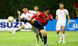 Do Duy Manh of Vietnam and Souk Aphone Vongchiekham of Laos challenge for the ball during...