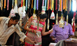Indian women shop for 'rakhi' (sacred thread) at a market ahead of the Hindu festival of R...