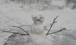 Small snowman during a snowfall that left around 5 centimeters snow accumulation in the ci...