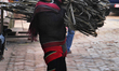 Newari woman carries a large bundle of wood along the road in the ancient city of Bhaktapu...