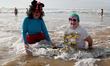People take part in a traditional sea bath to welcome the new year at Carcavelos beach dur...
