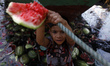 A street boy searching eatable watermelons from the polluted and filthy Buriganga River. B...