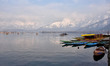 Boatmen row their boats on a sunny winter day in Dal lake, Srinagar, Indian Administered K...