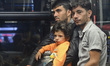 MMigrants on the board of one of the buses, as Hungary's surprise nighttime move to provid...
