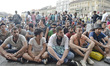 A group of mal migrants from Syria, Iran, Afganistan and other countries, seating and wait...