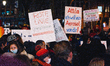 counter protesters are seen holding the signs against anti vaccination protest march in Co...