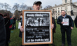 LONDON, UNITED KINGDOM - JANUARY 27, 2022: A man holds a placard during a vigil outside Ho...