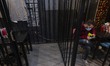 An Iranian man uses his smartphone as he sits at a cell in the CELL-16 fast food jail rest...