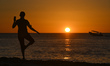 A woman enjoying a yoga session at sunset on Celestun Beach.On Thursday, February 17, 202...