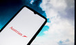 In this photo illustration a Austrian Airlines logo seen displayed on a smartphone screen...