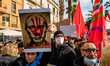 Protesters protest with placards in the square in front of the Municipality of Bari agains...
