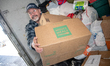 Volunteers with the Ukrainian-American Crisis Response Committee unload deliveries of supp...
