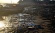 Piles of waste and garbage line the banks of a polluted River Ganges  in the Indian town o...