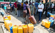 Sri Lankan People waite to buy diesel fuel at a fuel station in Colombo on March 28, 2022....