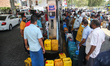 Sri Lankan People waite to buy diesel fuel at a fuel station in Colombo on March 28, 2022....