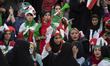 An Iranian policewoman talks to a soccer female fan at the Azadi (Freedom) stadium in west...
