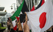 Scout members raise the flag of the Asian-African conference members on April 18, 2022, at...
