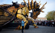 An operator stands guard near Long-Ma before the beginning of the spectacle. A robot, a ma...