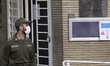 An Iranian policeman stands guard in front of the Sweden Embassy in northern Tehran during...
