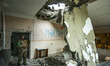 A ukrainian soldier looks the aftermath of a russian shelling over a school in Luch, a vil...