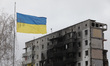 BORODIANKA, UKRAINE - APRIL 16, 2022 - A Ukrainian flag flies in front of an apartment bui...