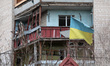 BORODIANKA, UKRAINE - APRIL 16, 2022 - A Ukrainian flag flies in front of an apartment bui...
