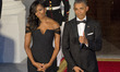 United States President Barack Obama flashes a thumbs-up as he and First Lady Michelle Oba...