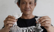 Cepi, one of the residents of the flat, show the coal dust he collected from the floor of...